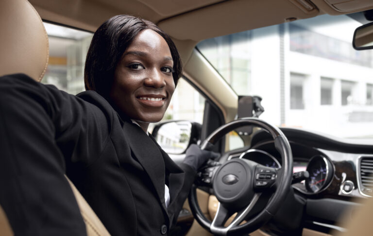 female-taxi-driver-looking-back-car